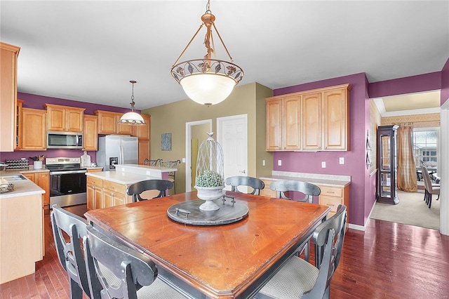 dining room featuring dark wood-type flooring and baseboards