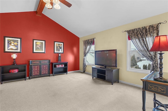 sitting room with vaulted ceiling with beams, carpet, baseboards, and ceiling fan