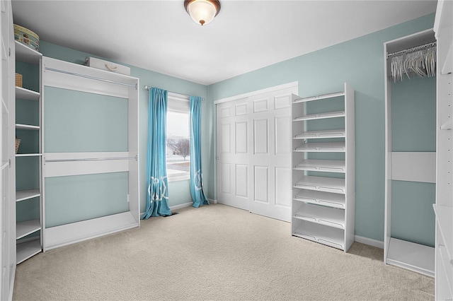 unfurnished bedroom featuring carpet floors and baseboards