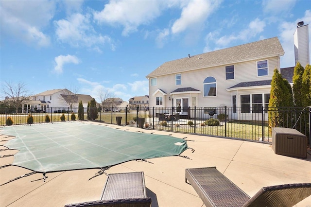 view of pool featuring a patio, fence, and a residential view