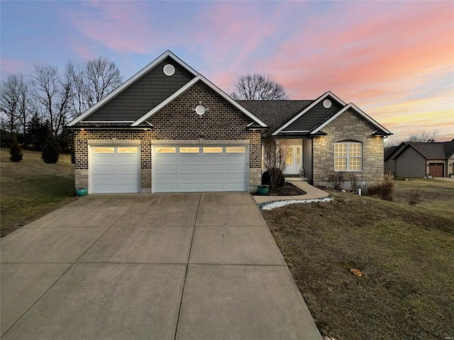 view of front of house featuring a garage and a lawn