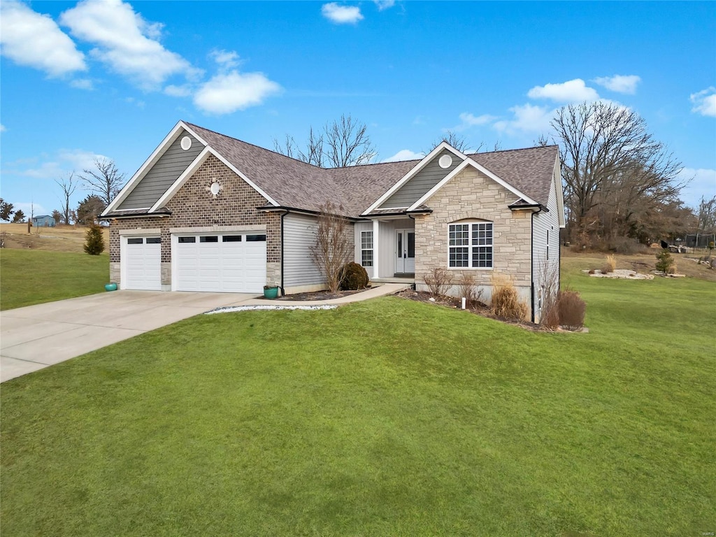 view of front of home featuring a garage and a front lawn