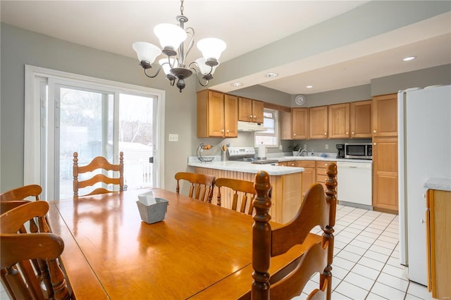 dining area with recessed lighting, light tile patterned flooring, and an inviting chandelier