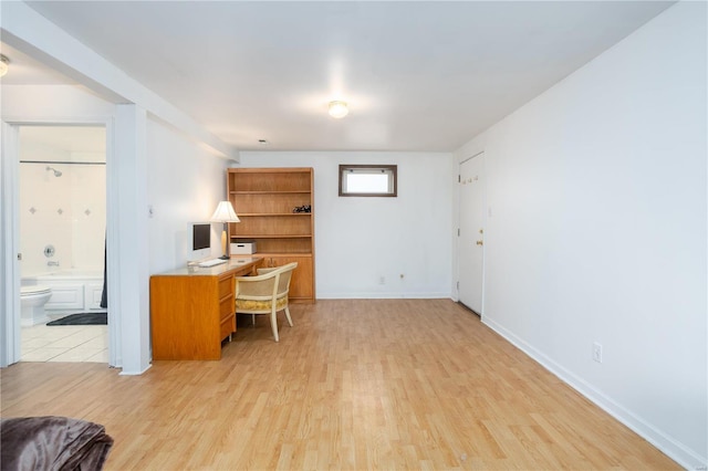 office area with light wood-type flooring and baseboards