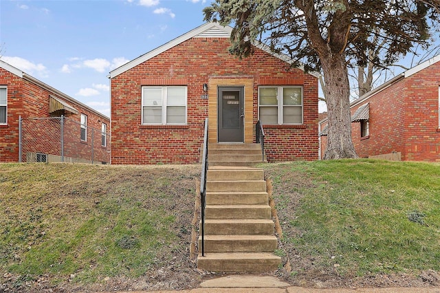 bungalow-style home featuring a front lawn