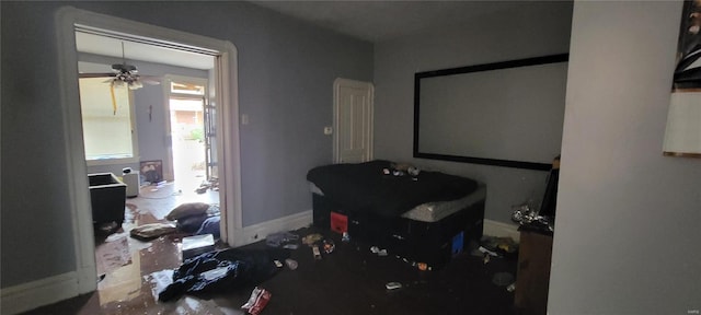 interior space featuring a ceiling fan and baseboards