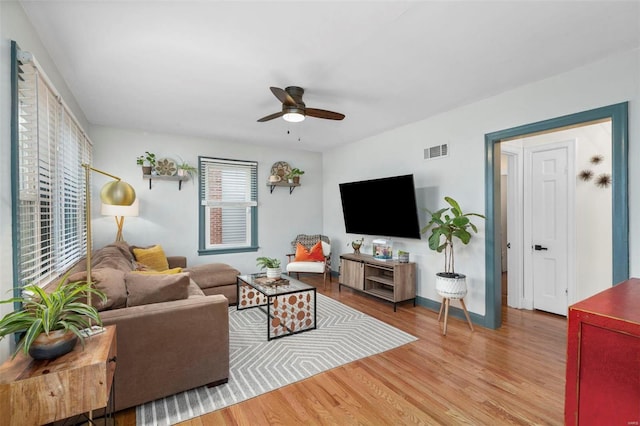 living room with ceiling fan and light hardwood / wood-style floors