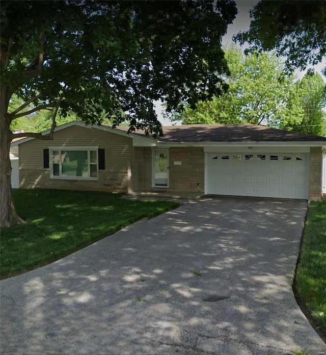 single story home with a garage and a front lawn