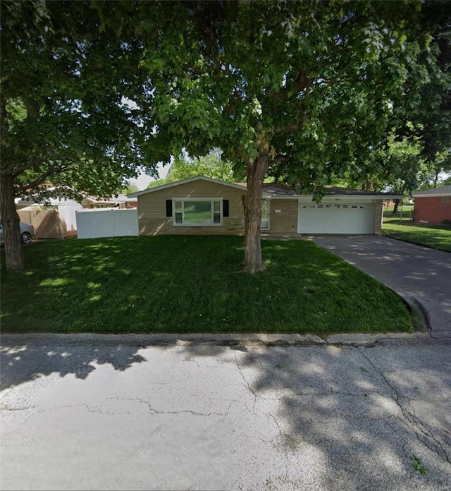 single story home featuring a garage and a front lawn