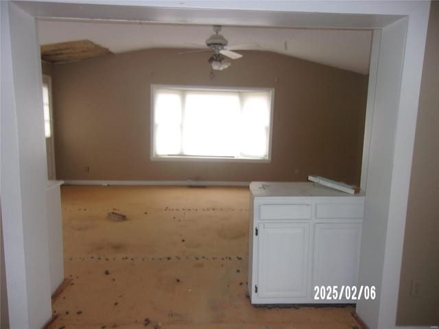 spare room featuring vaulted ceiling and ceiling fan