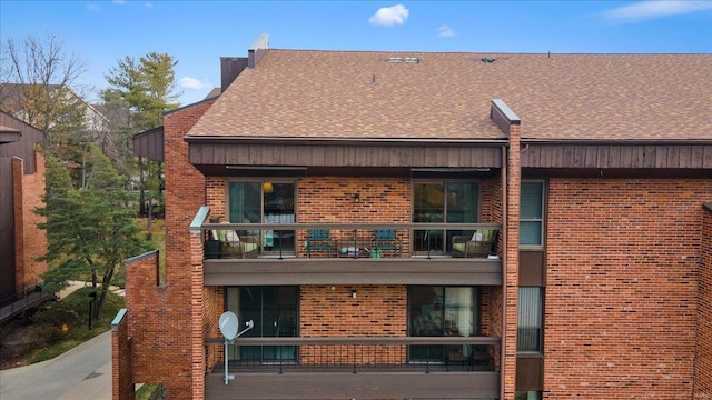 back of property featuring a balcony