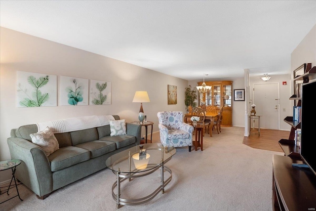 living room featuring an inviting chandelier and carpet flooring