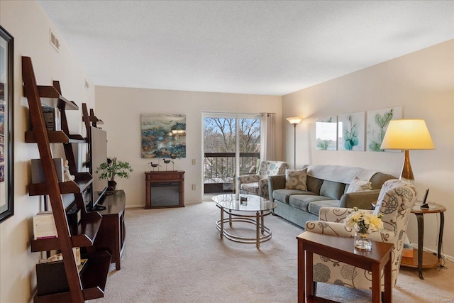 living room featuring light colored carpet and a textured ceiling