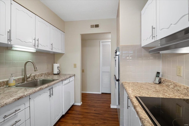 kitchen featuring sink, dark wood-type flooring, white cabinetry, white dishwasher, and black electric stovetop