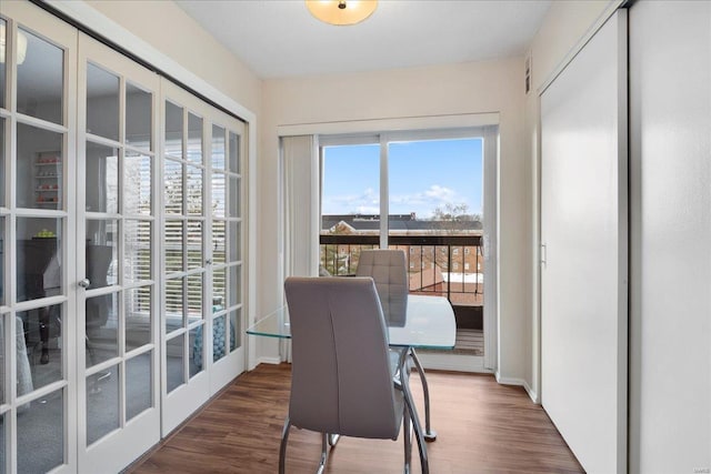 dining area featuring dark wood-type flooring and french doors