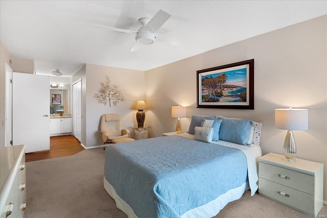 carpeted bedroom featuring ensuite bathroom and ceiling fan