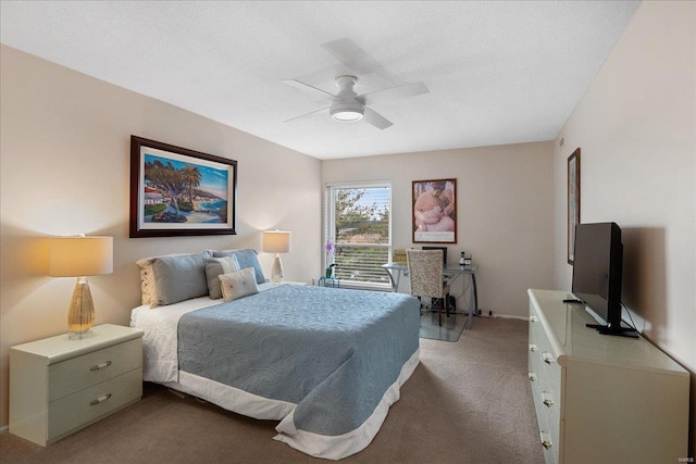 carpeted bedroom featuring ceiling fan and a textured ceiling