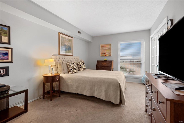 carpeted bedroom with a textured ceiling