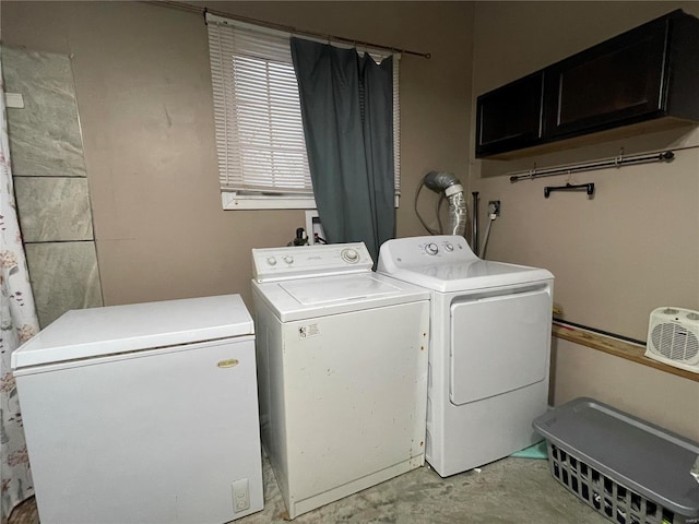 washroom with washing machine and dryer and cabinet space