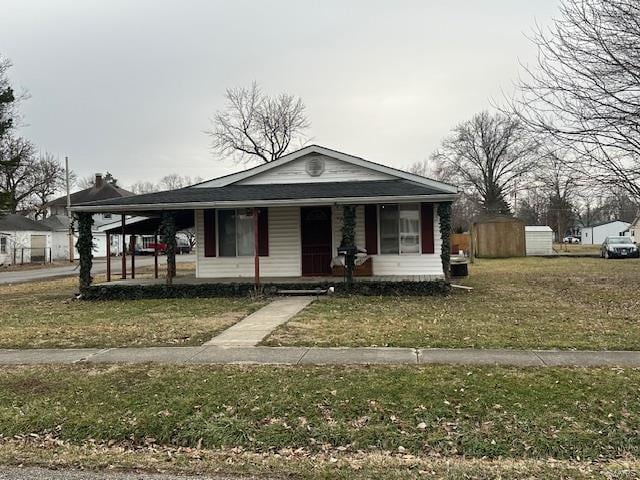 view of front facade with a front yard and covered porch