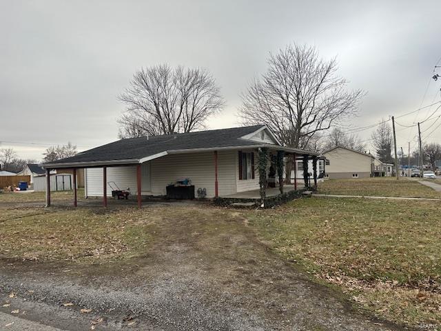 view of home's exterior with a carport and a yard