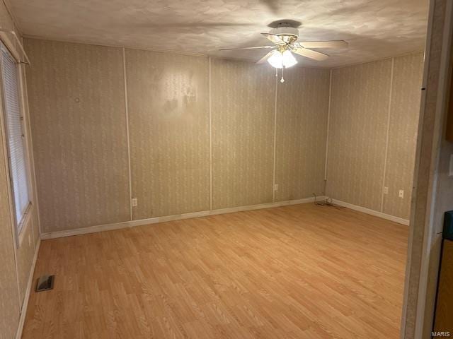 unfurnished room with ceiling fan and light wood-type flooring