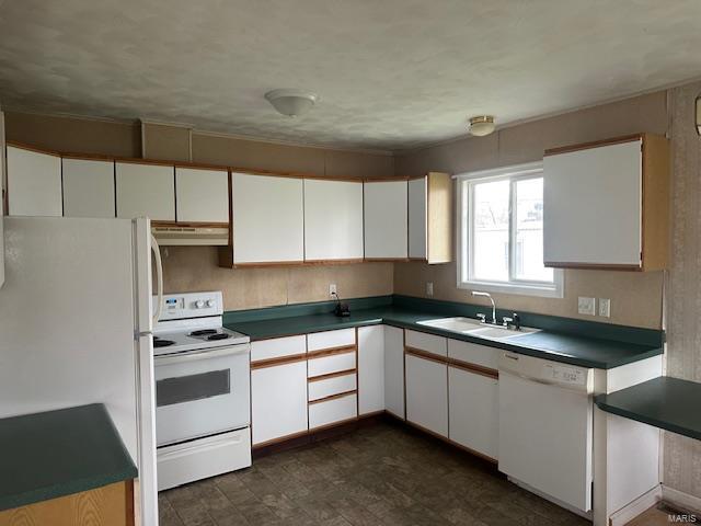 kitchen featuring white appliances, white cabinets, under cabinet range hood, and a sink