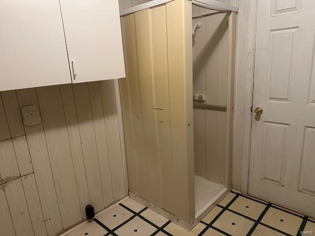 mudroom featuring wooden walls