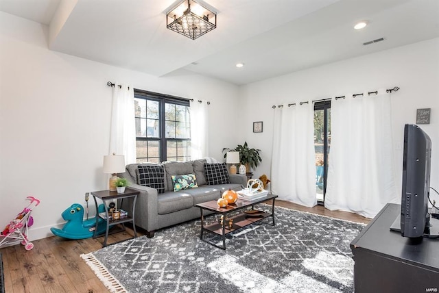 living room featuring hardwood / wood-style floors and an inviting chandelier