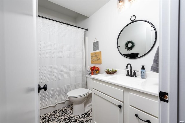 bathroom featuring vanity, toilet, and tile patterned flooring