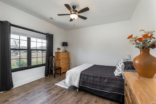 bedroom featuring hardwood / wood-style flooring and ceiling fan