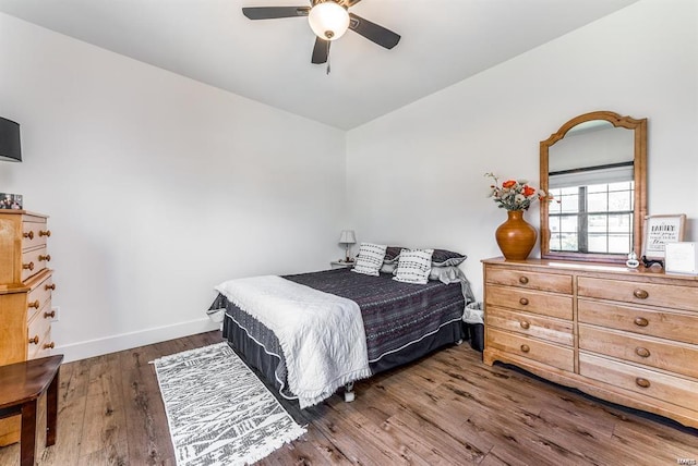 bedroom featuring ceiling fan, lofted ceiling, and dark hardwood / wood-style floors