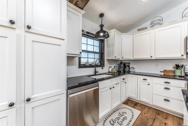 kitchen featuring pendant lighting, sink, lofted ceiling, dishwasher, and white cabinets