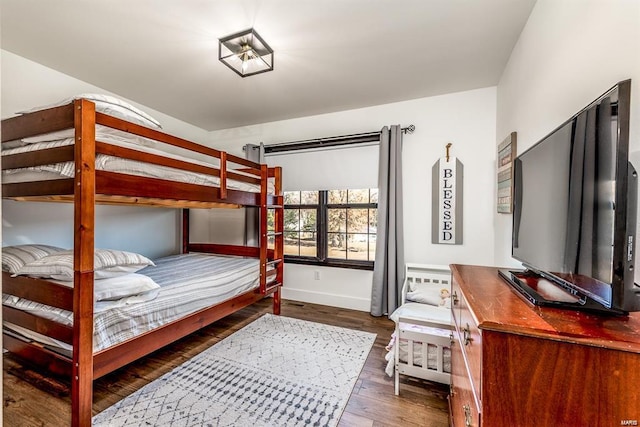 bedroom with dark hardwood / wood-style floors