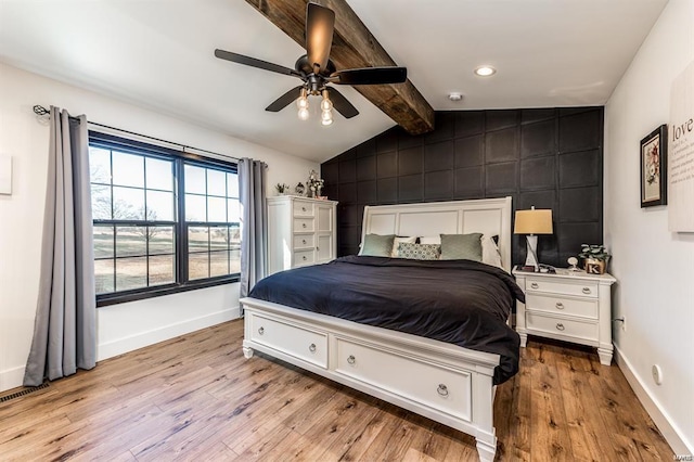 bedroom with lofted ceiling with beams, ceiling fan, and light hardwood / wood-style flooring