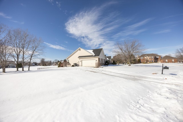 view of snow covered exterior with a garage