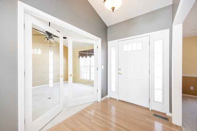 entryway featuring french doors, ceiling fan, and wood-type flooring