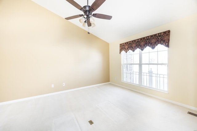 carpeted empty room with lofted ceiling and ceiling fan