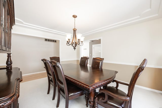 dining room with an inviting chandelier and light hardwood / wood-style flooring