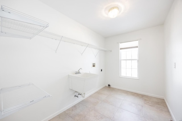 washroom featuring hookup for a washing machine, sink, electric dryer hookup, and light tile patterned floors