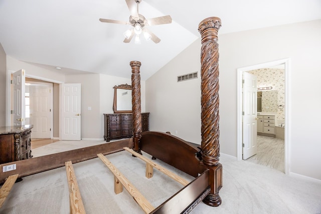 carpeted bedroom featuring lofted ceiling, connected bathroom, and ceiling fan