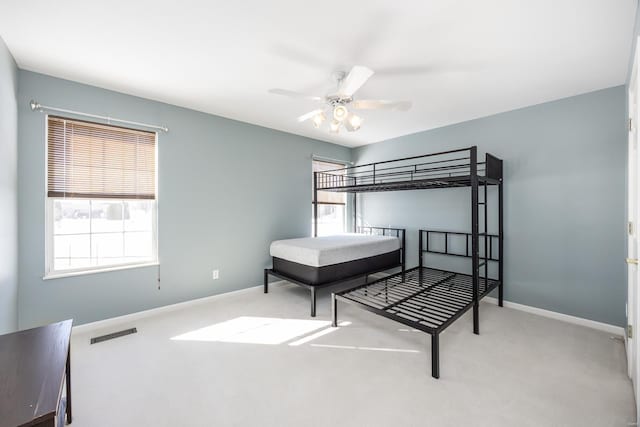 bedroom with light carpet and ceiling fan