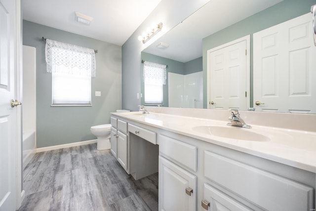 full bathroom featuring bathtub / shower combination, toilet, vanity, and wood-type flooring