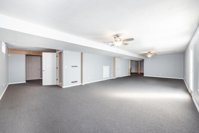 interior space with ceiling fan and dark colored carpet