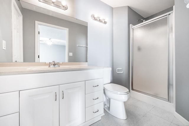 bathroom with toilet, vanity, and walk in shower