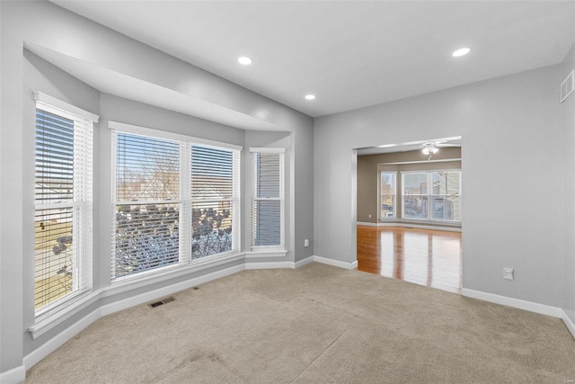 empty room with recessed lighting, baseboards, visible vents, and carpet flooring