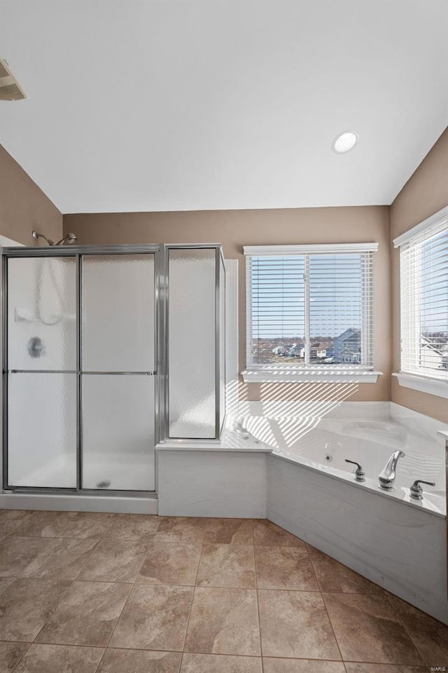 bathroom with a stall shower, visible vents, lofted ceiling, tile patterned flooring, and a bath