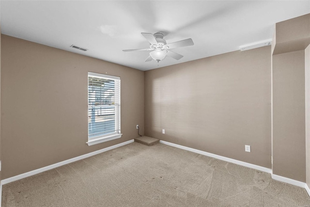 unfurnished room featuring baseboards, visible vents, and light colored carpet