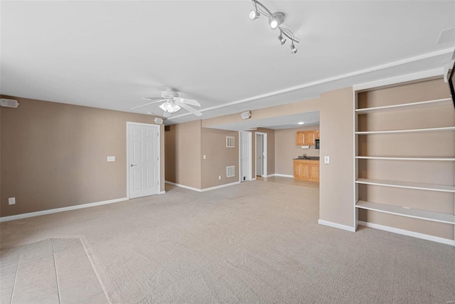 unfurnished living room with light carpet, ceiling fan, visible vents, and baseboards