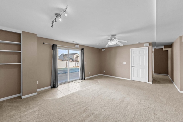 interior space featuring access to exterior, carpet floors, baseboards, and a ceiling fan